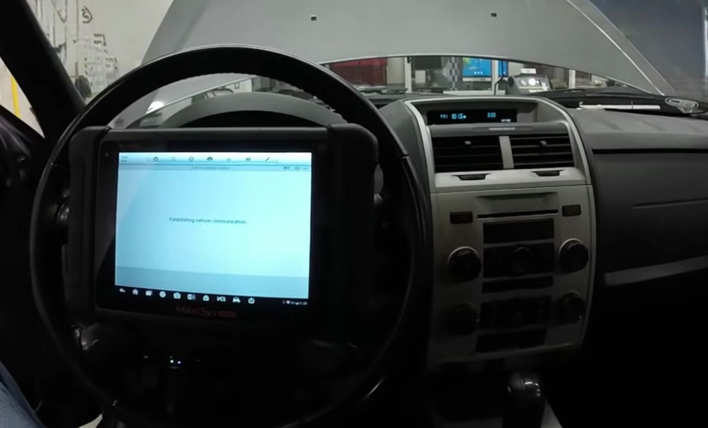 A Technician Scanning a vehicle for Trouble Codes.