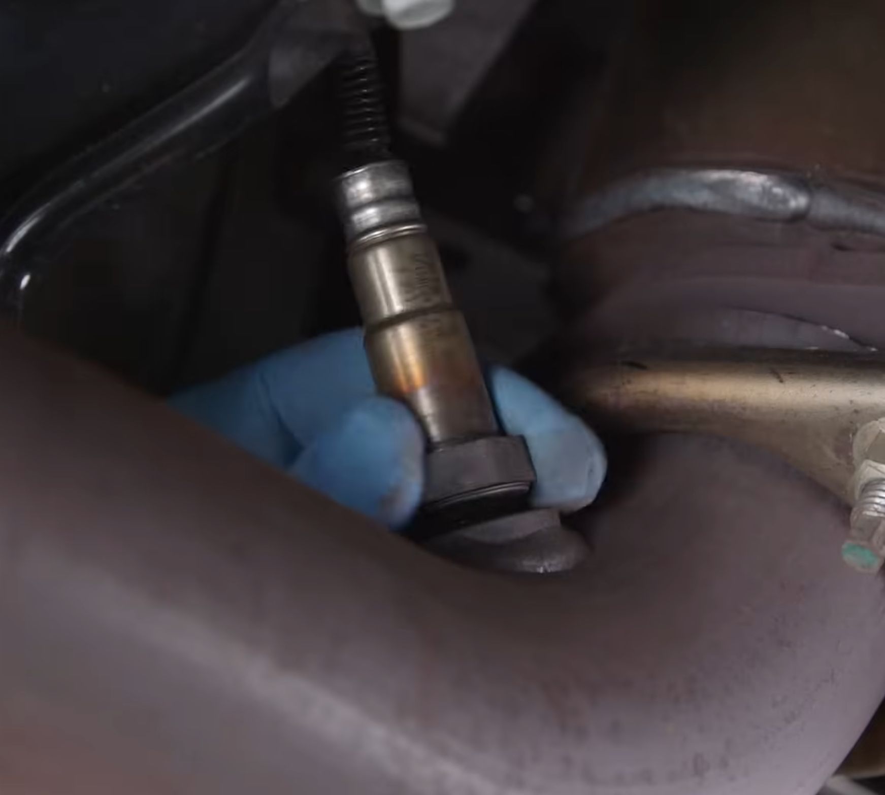 An Automotive Technician replacing an Oxygen Sensor.
