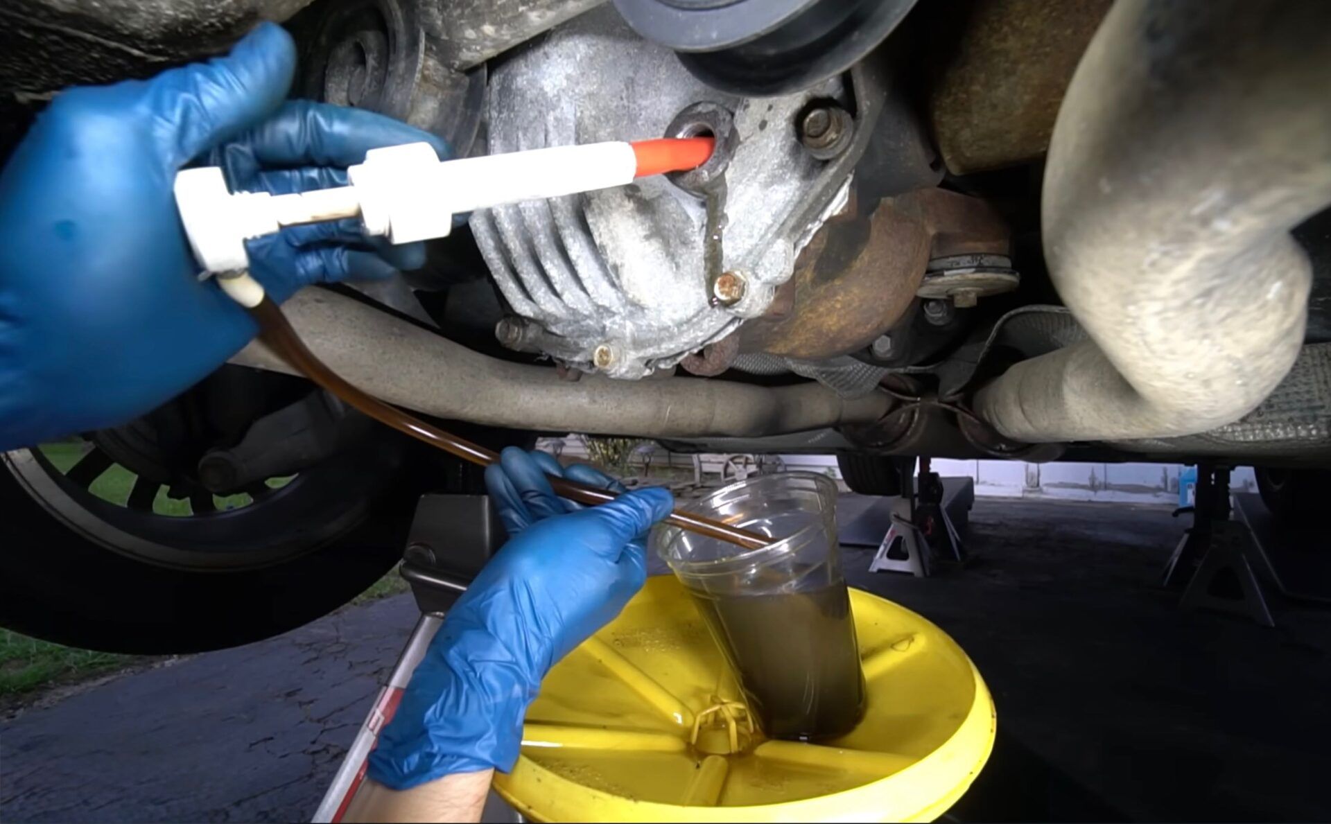 Technician pumping differential fluid out.