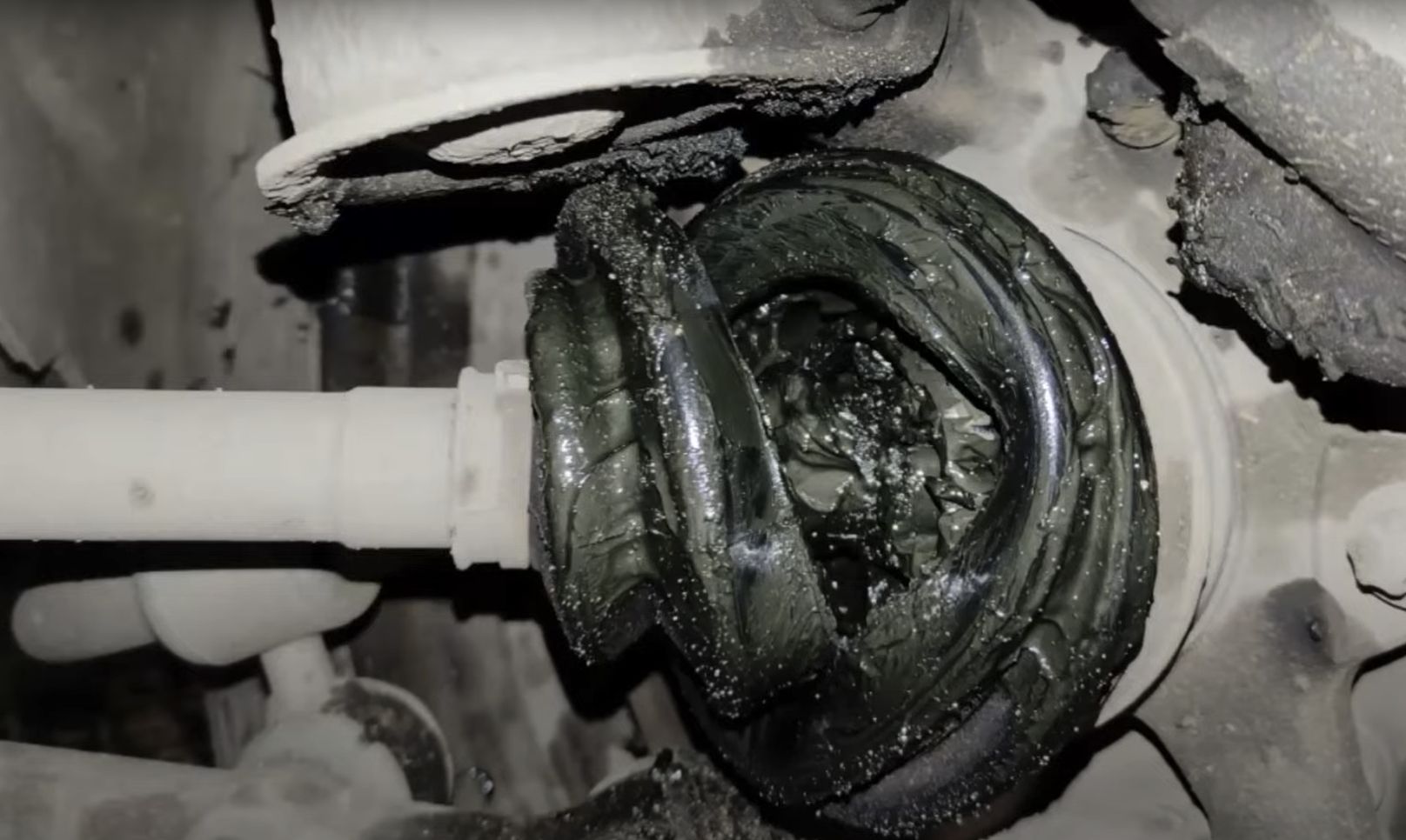 A CV (Constant Velosity) Joint on an axle with a torn boot.