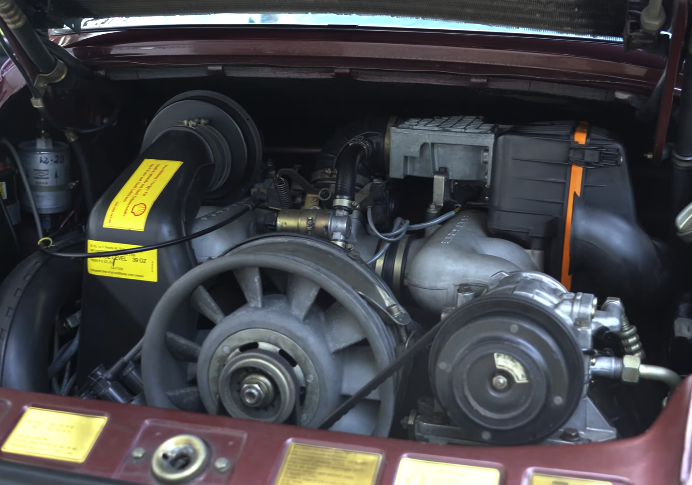 Air-cooled Porsche 911 Engine | Temecula Auto Repair & Transmission The rear decklid open on an air-cooled Porsche 911, showing the engine.
