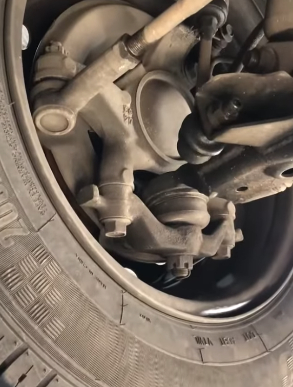 A worn ball joint on a passenger car.