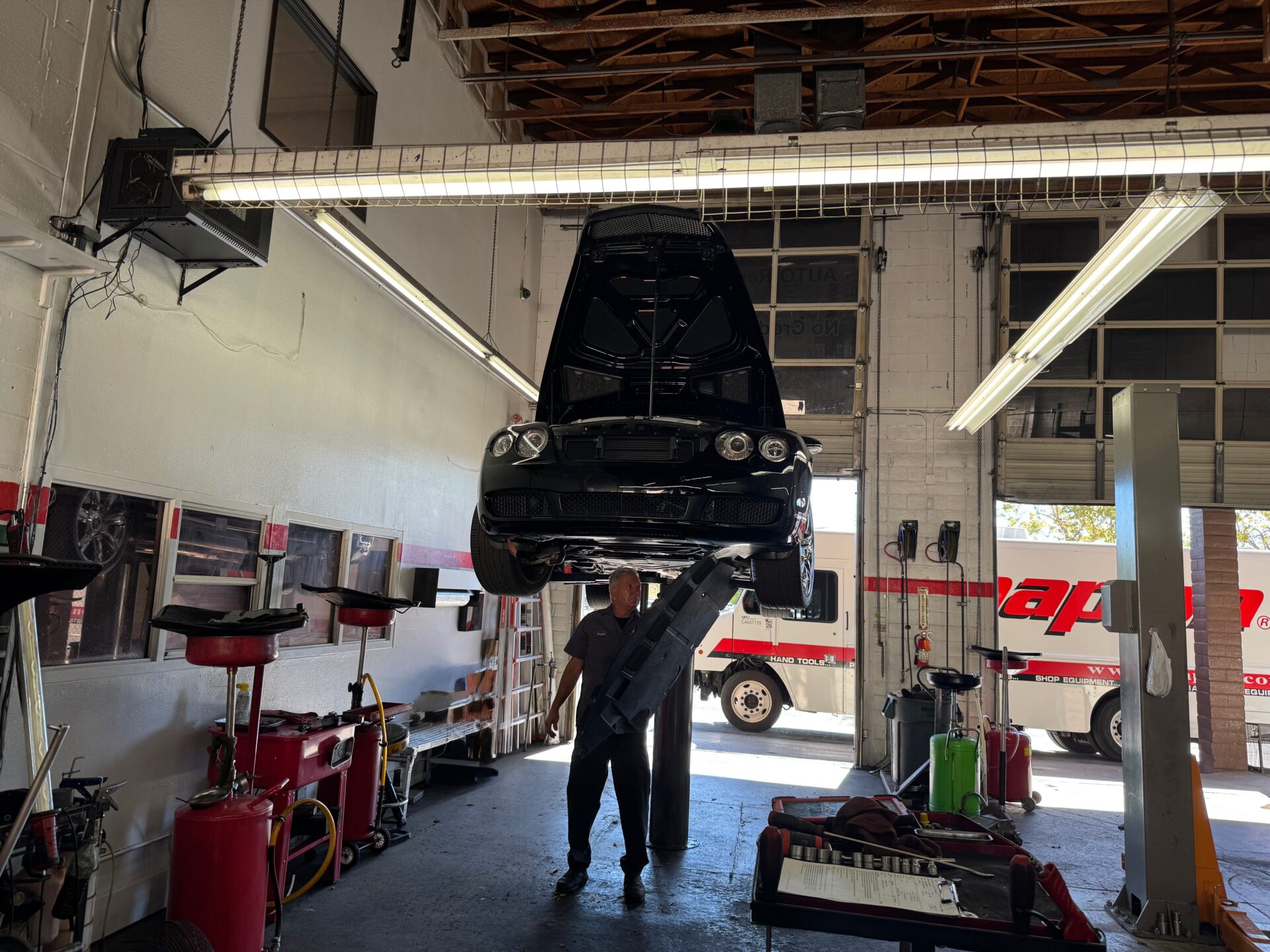 Bentley Service Maintenance in Temecula Murrieta | Temecula Auto Repair & Transmission Automotive Technician performing a transmission fluid maintenance service on a Bentley.