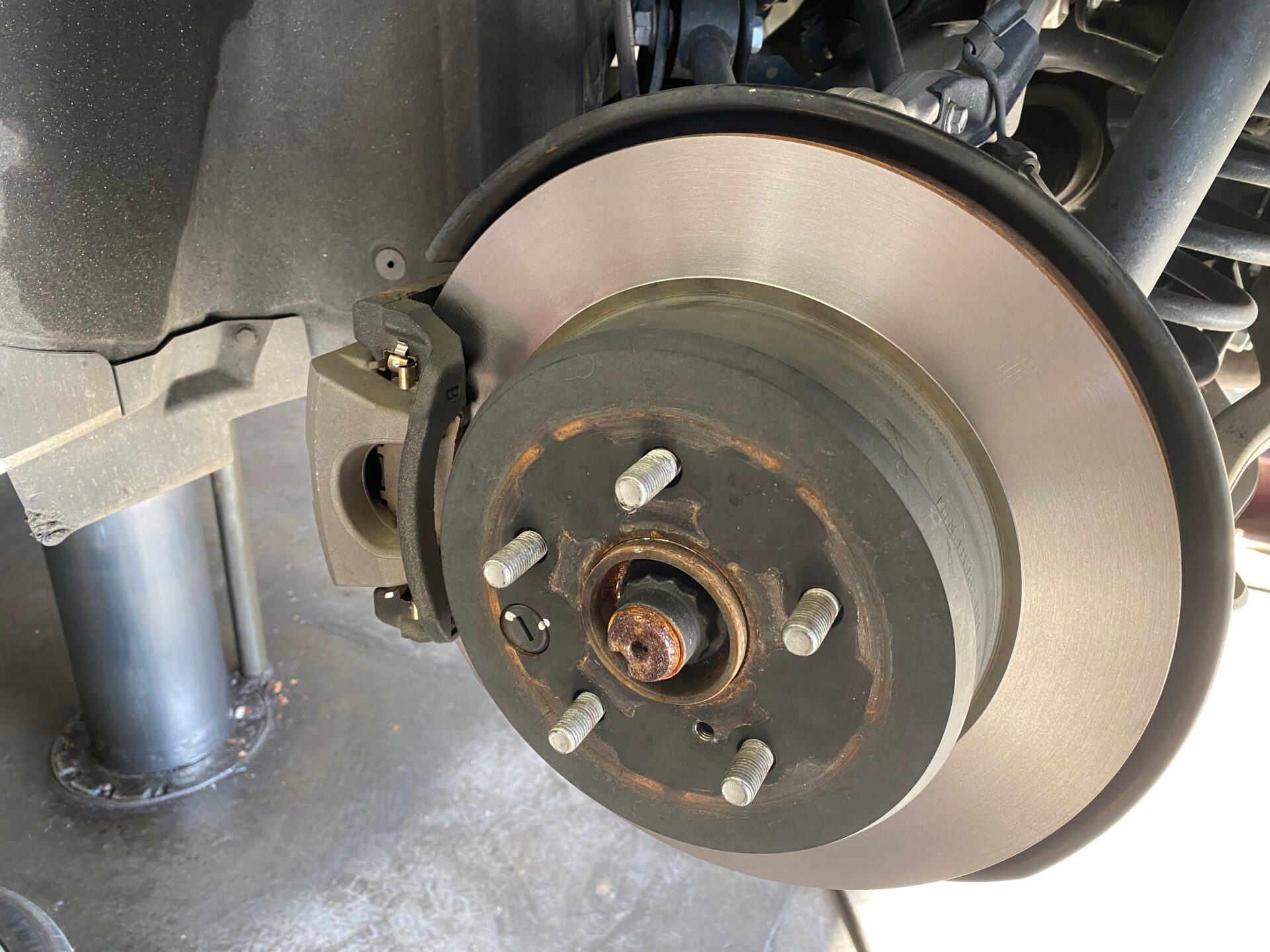 Brake pads and rotors on a car.