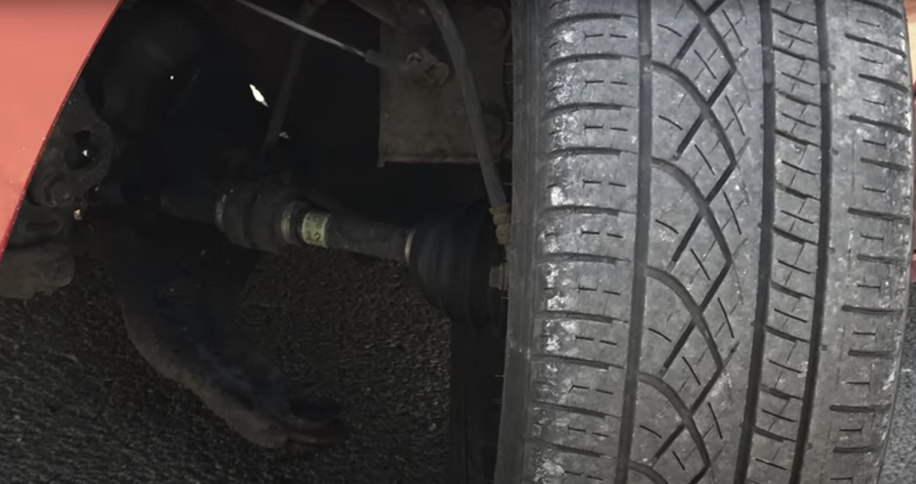 Left side CV Axle shaft is visible with wheel turned outward.