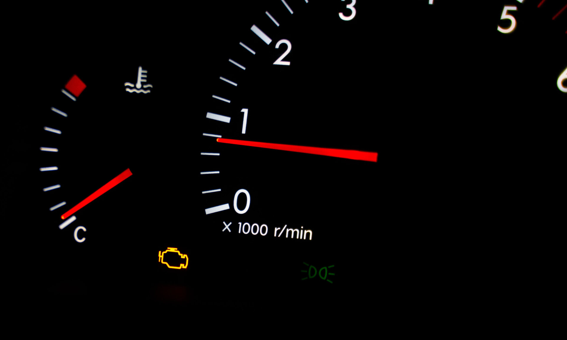 Check engine warning light glowing orange on a dark dashboard | Temecula Auto Repair & Transmission Check Engine Light is on in a dashboard.