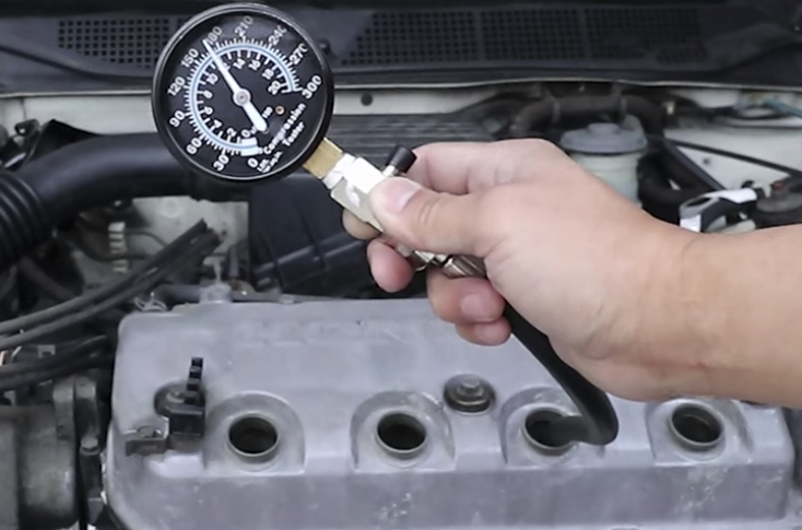 Engine Compression Test | Temecula Auto Repair & Transmission A compression test is being performed on an engine.