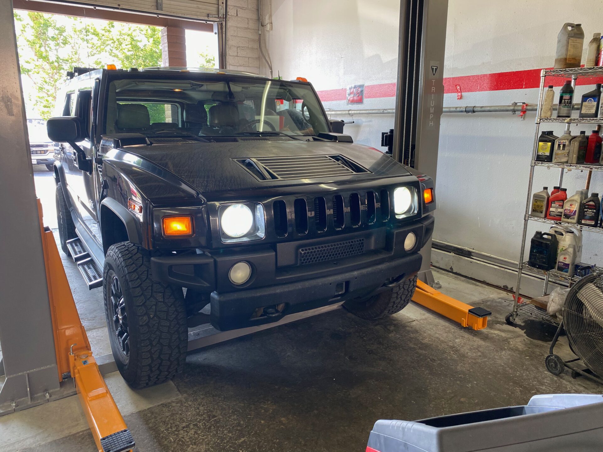 H2 Hummer at Temecula Auto Repair & Transmission | Temecula Auto Repair & Transmission Black H2 Hummer in the service bay at Temecula Auto Repair & Transmission