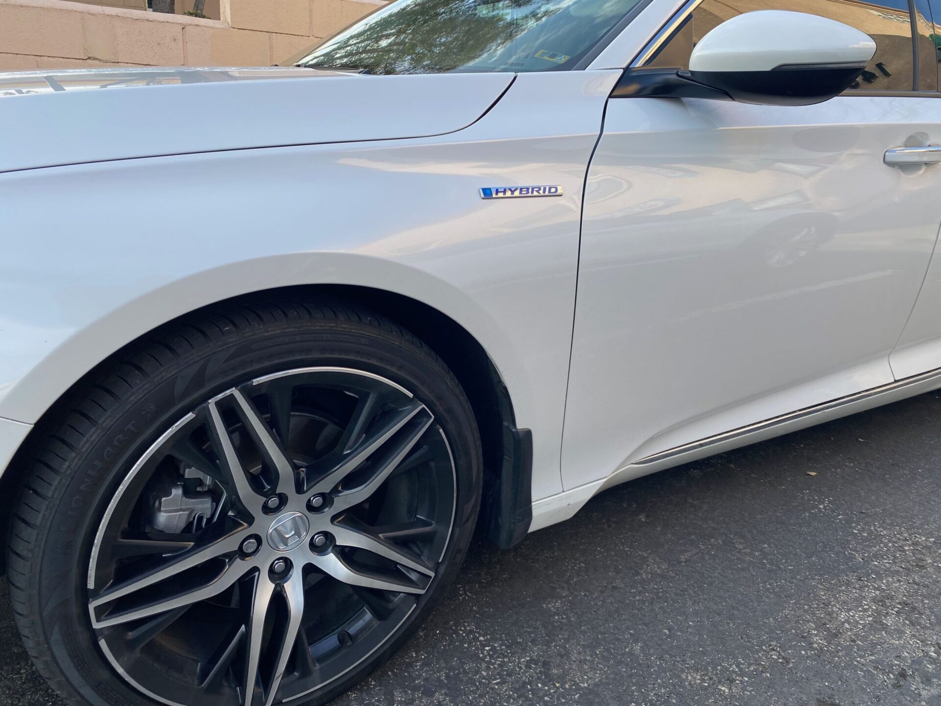 Honda Accord Hybrid Temecula Auto Repair | Temecula Auto Repair & Transmission White Honda Accord left front fender view with "Hybrid" emblem in view.