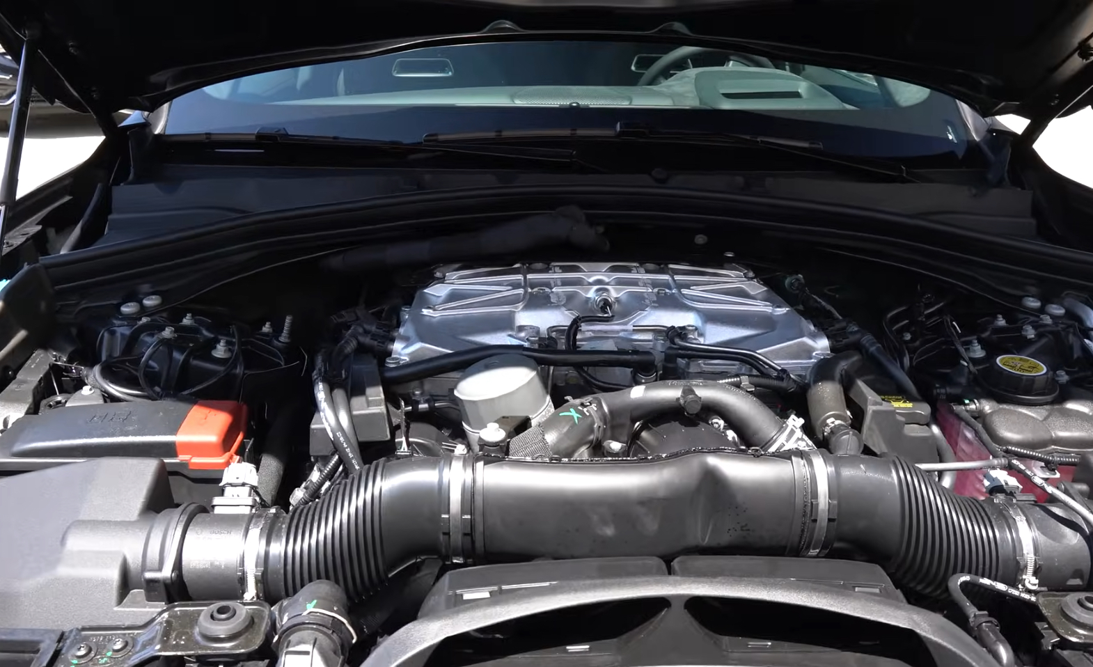 Jaguar Engine Cooling System | Temecula Auto Repair & Transmission The hood is open on a Jaguar F-Pace, showing the engine and cooling system.