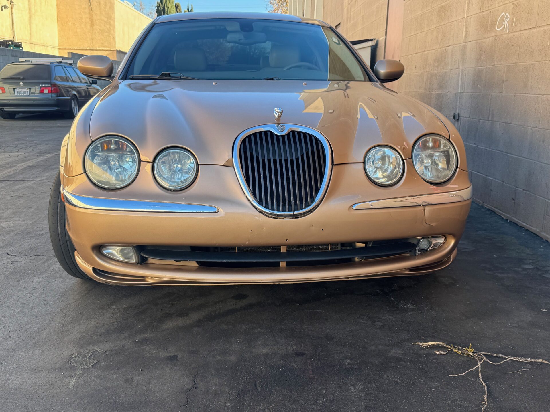 Jaguar S-Type at Temecula Auto Repair | Temecula Auto Repair & Transmission A gold color Jaguar S-Type at Temecula Auto Repair for service.