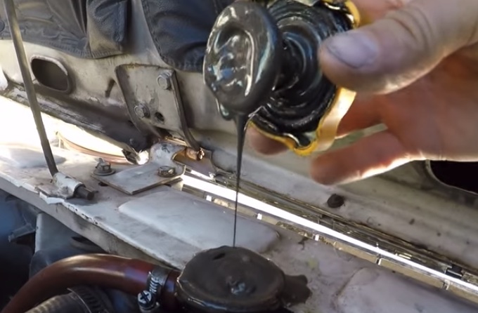 Oil Mixing With Coolant | Temecula Auto Repair & Transmission Radiator cap with oil on it, indicating oil mixing with coolant.