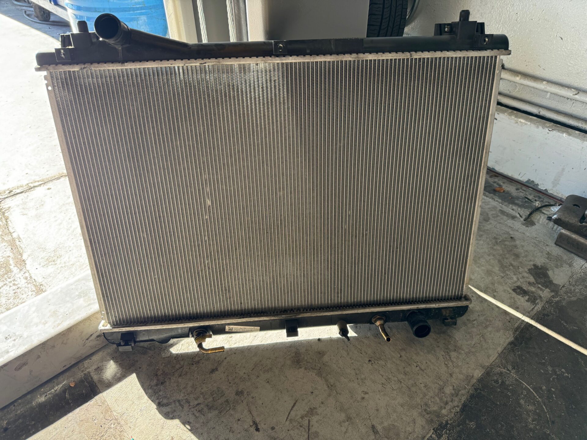 New Replacement Radiator | Temecula Auto Repair & Transmission A replacement radiator before its installation into a car at Temecula Auto Repair.