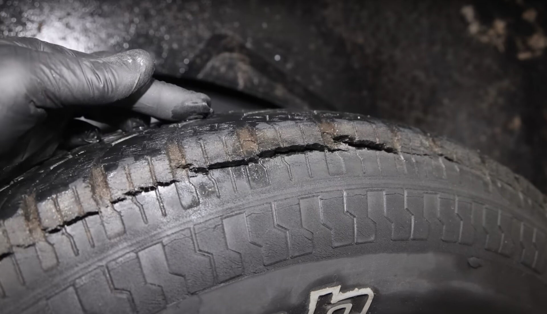 Tire Dry-rotted | Temecula Auto Repair & Transmission A dry-rotted tire with its tread badly cracking.