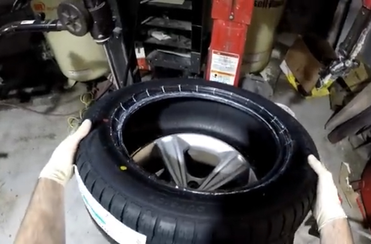 Tire Installation | Temecula Auto Repair & Transmission An automotive technician is installing a tire on a rim.