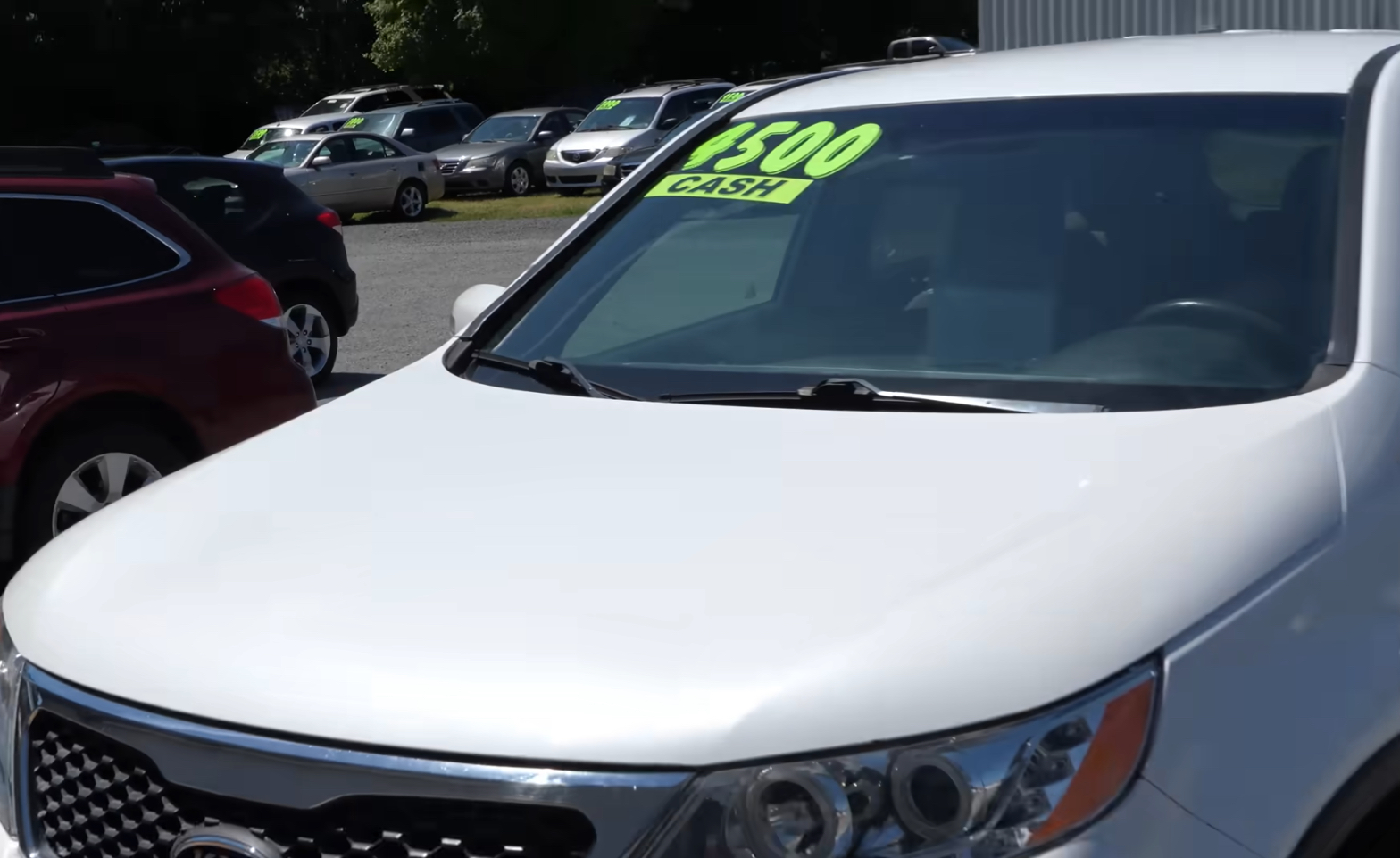 Used Car With Pricing Stickers | Temecula Auto Repair & Transmission A used car dealership with used cars on display